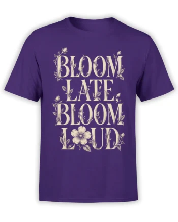 Purple floral graphic T-shirt with cream BLOOM LATE BLOOM LOUD lettering and botanical flower artwork