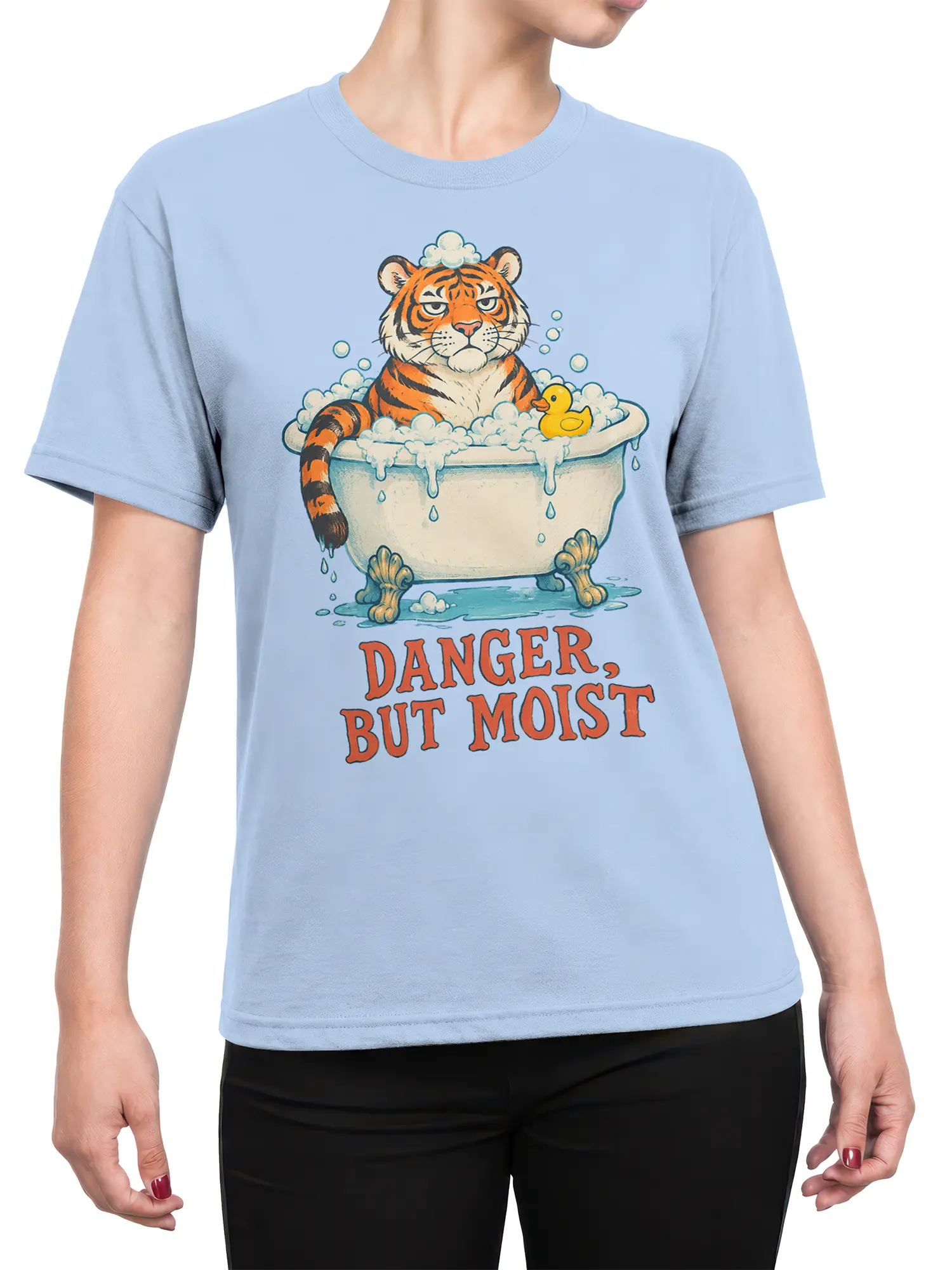 Female torso wearing a light blue tiger T-shirt with a bathtub scene, rubber duck, bubbles, and humorous slogan