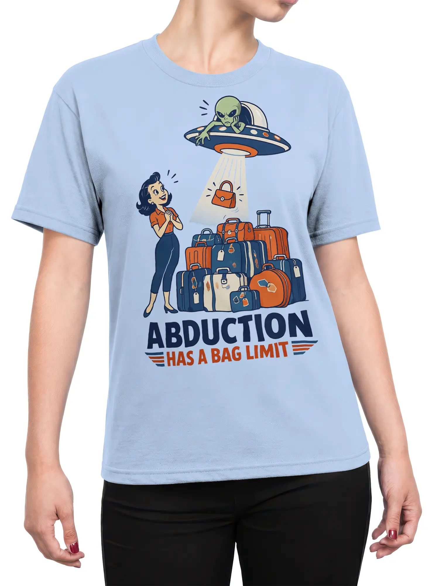 Female torso wearing a light blue alien travel T-shirt with a UFO, luggage, and retro abduction artwork
