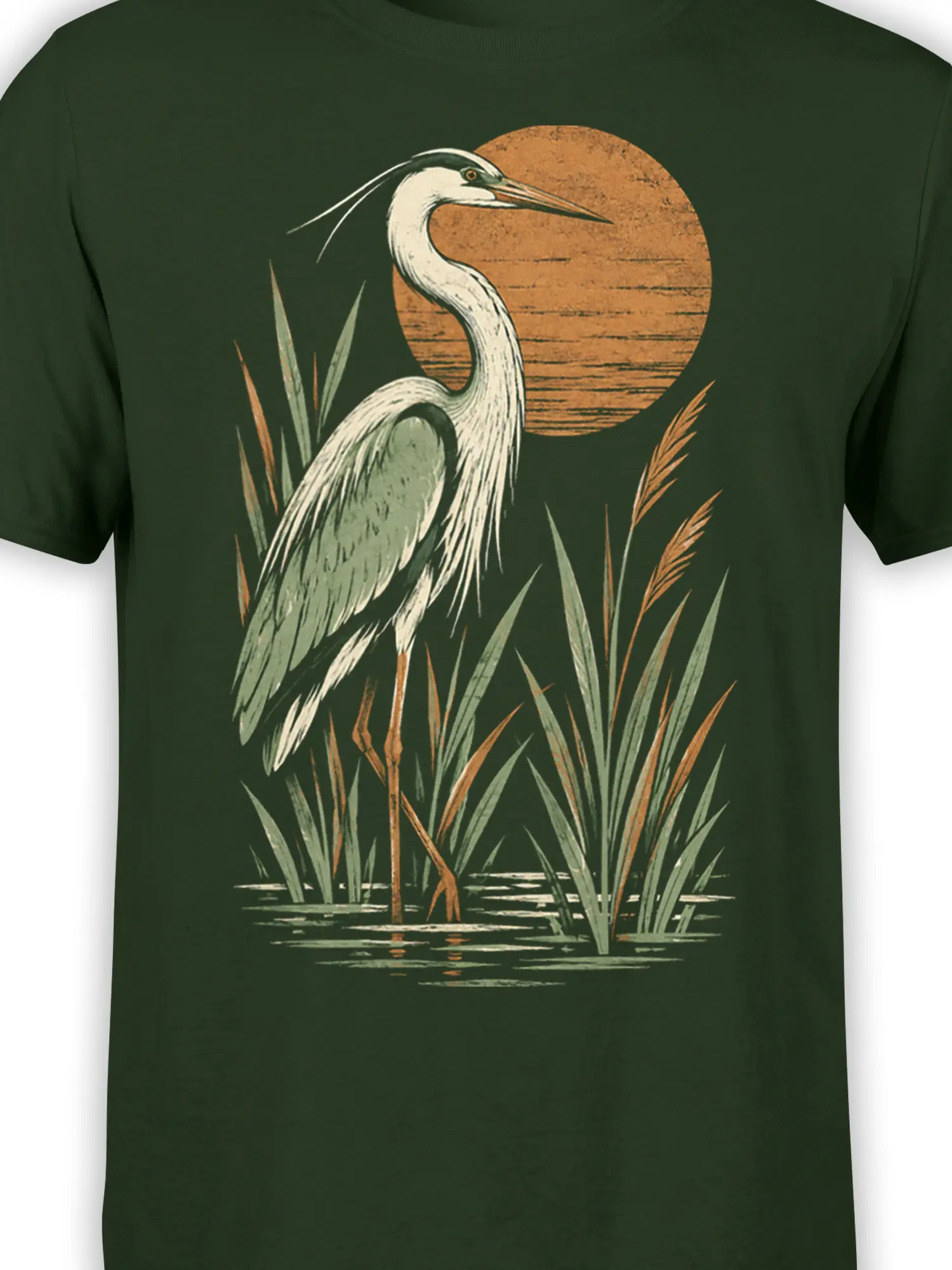 Close-up of the heron, reeds, water, and warm orange sky artwork on a dark green shirt
