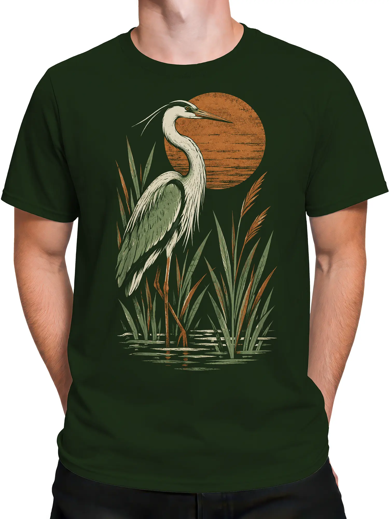 Male torso wearing a dark green vintage heron t-shirt with reeds, shallow water, and a warm sky