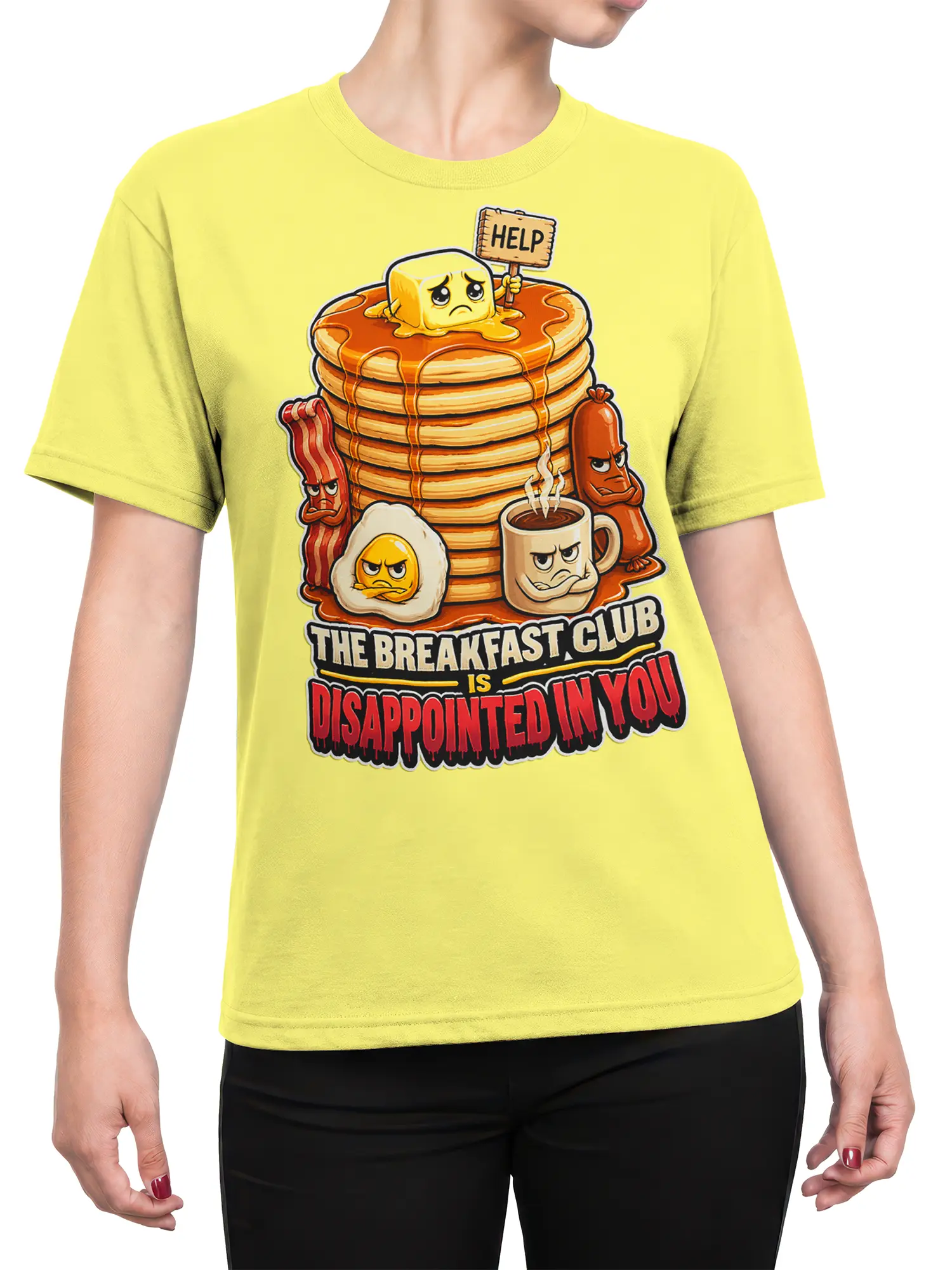 Female torso wearing a yellow breakfast t-shirt with grumpy pancakes, bacon, egg, coffee, and sarcastic text