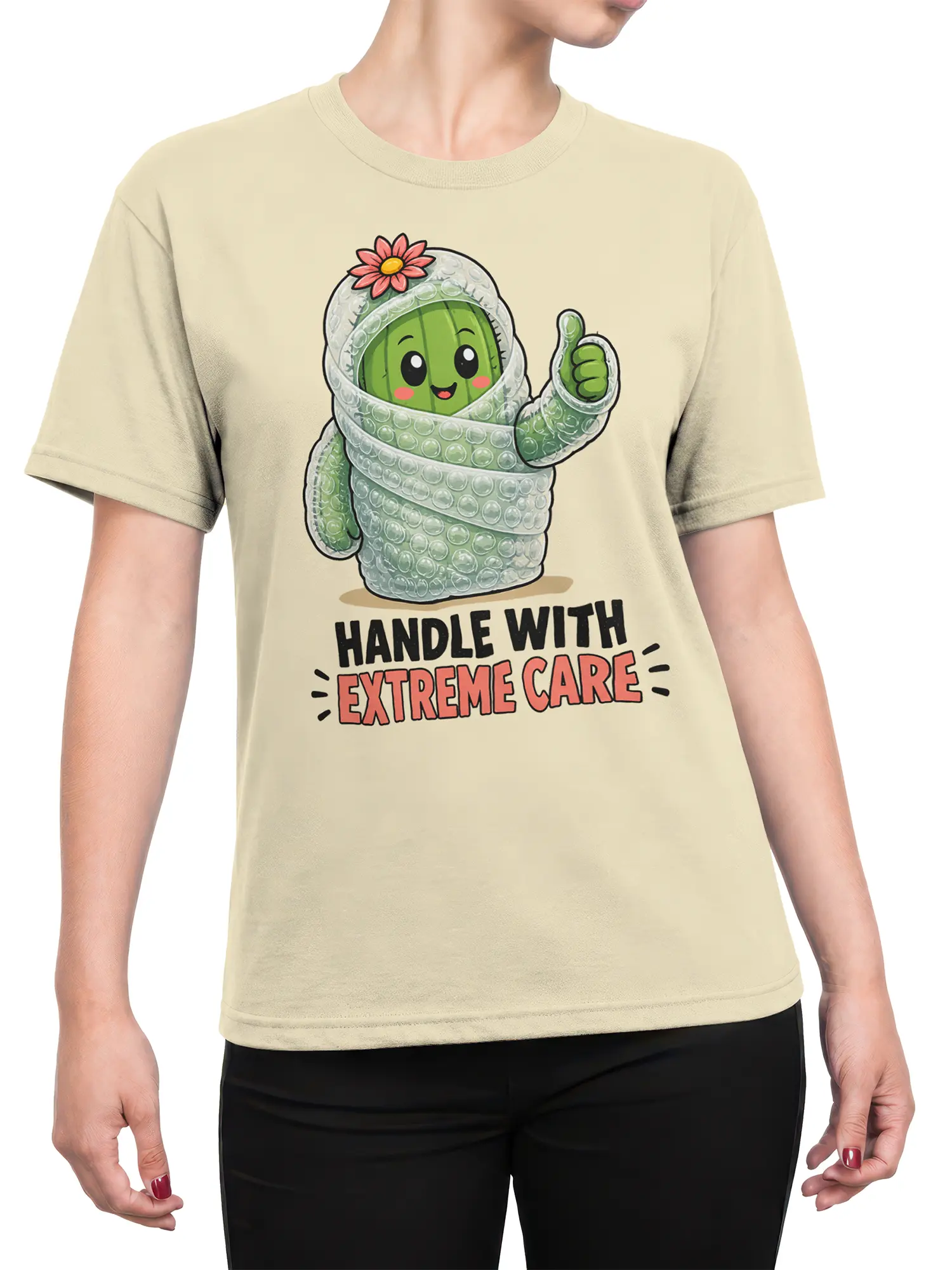 Female torso wearing a beige cactus graphic tee with bubble wrap, pink flower, thumbs-up, and care message