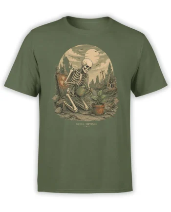 Skeleton watering a potted plant among ruins on a green Still Trying graphic T-shirt