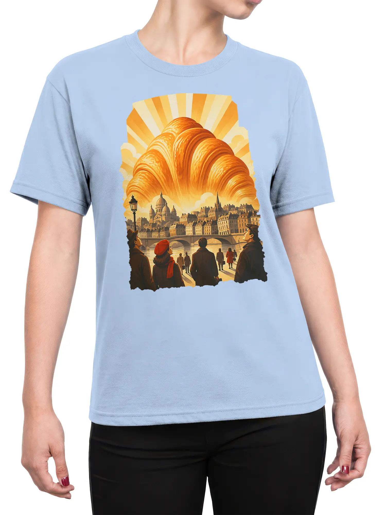 Female torso wearing a light blue Paris graphic tee with a golden croissant and vintage city illustration