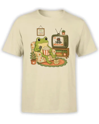 Cozy green frog watching retro fly news with popcorn on a beige graphic T-shirt