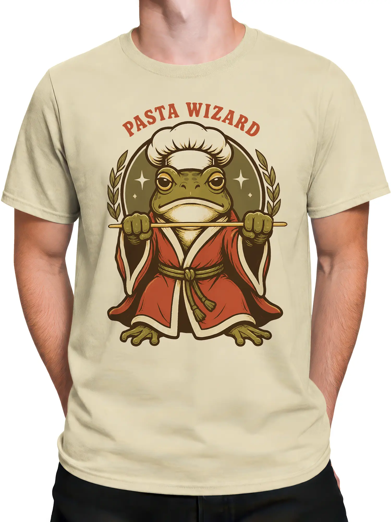 Male torso wearing a beige frog chef wizard T-shirt with Pasta Wizard artwork