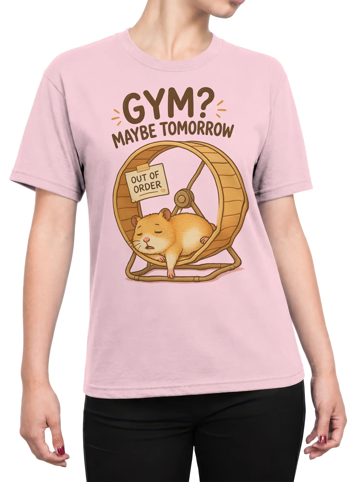 Female torso wearing a light pink hamster gym joke T-shirt with a sleepy wheel illustration and bold brown lettering