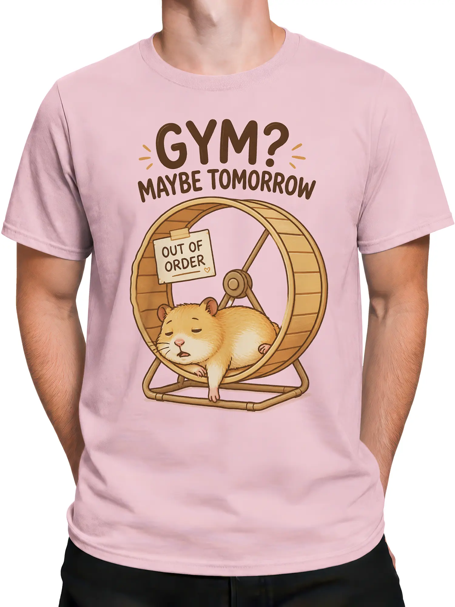 Male torso wearing a light pink hamster T-shirt with a wooden exercise wheel and “GYM? MAYBE TOMORROW” design