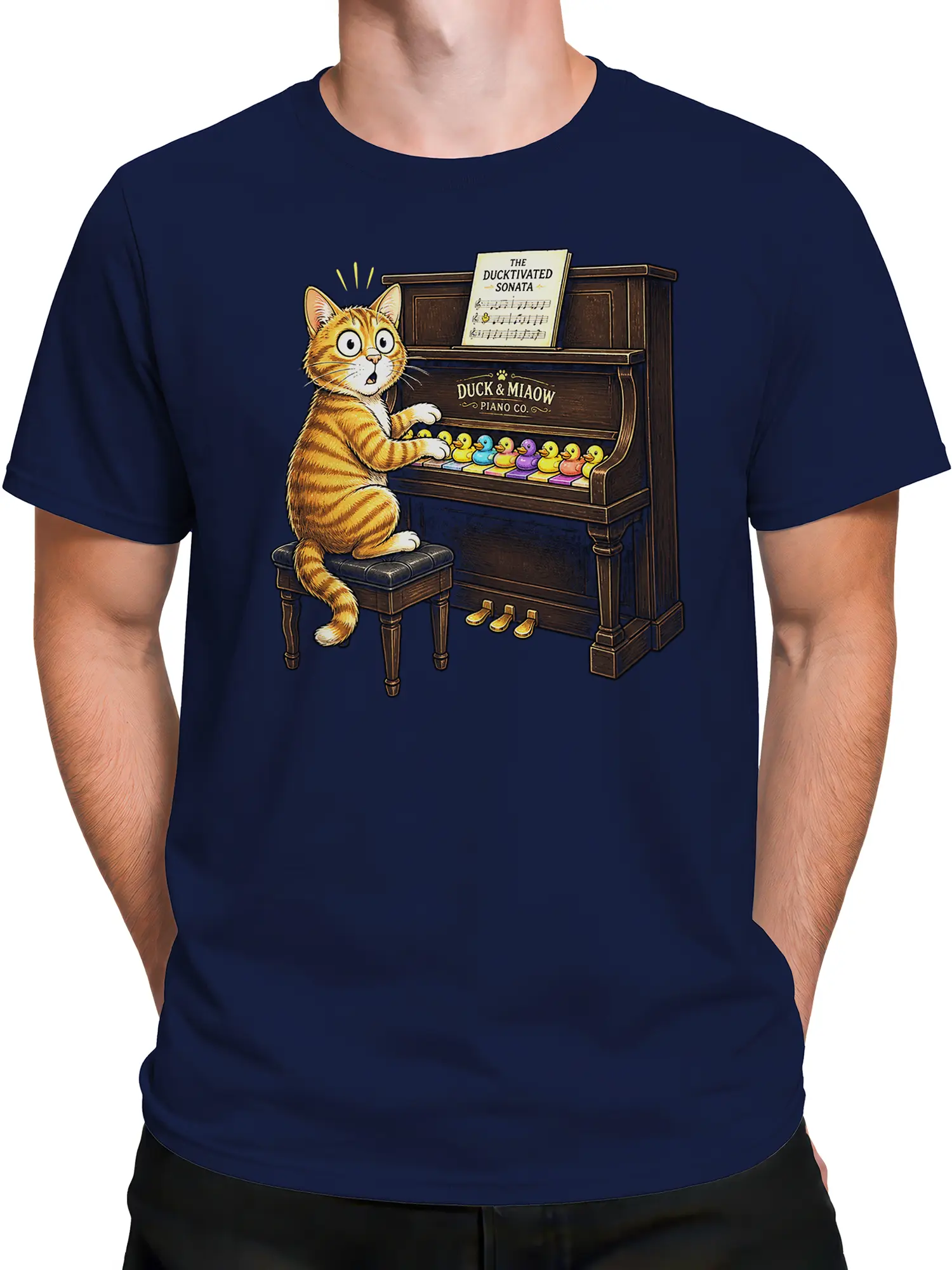 Male torso wearing a navy T-shirt with an orange cat piano concert design