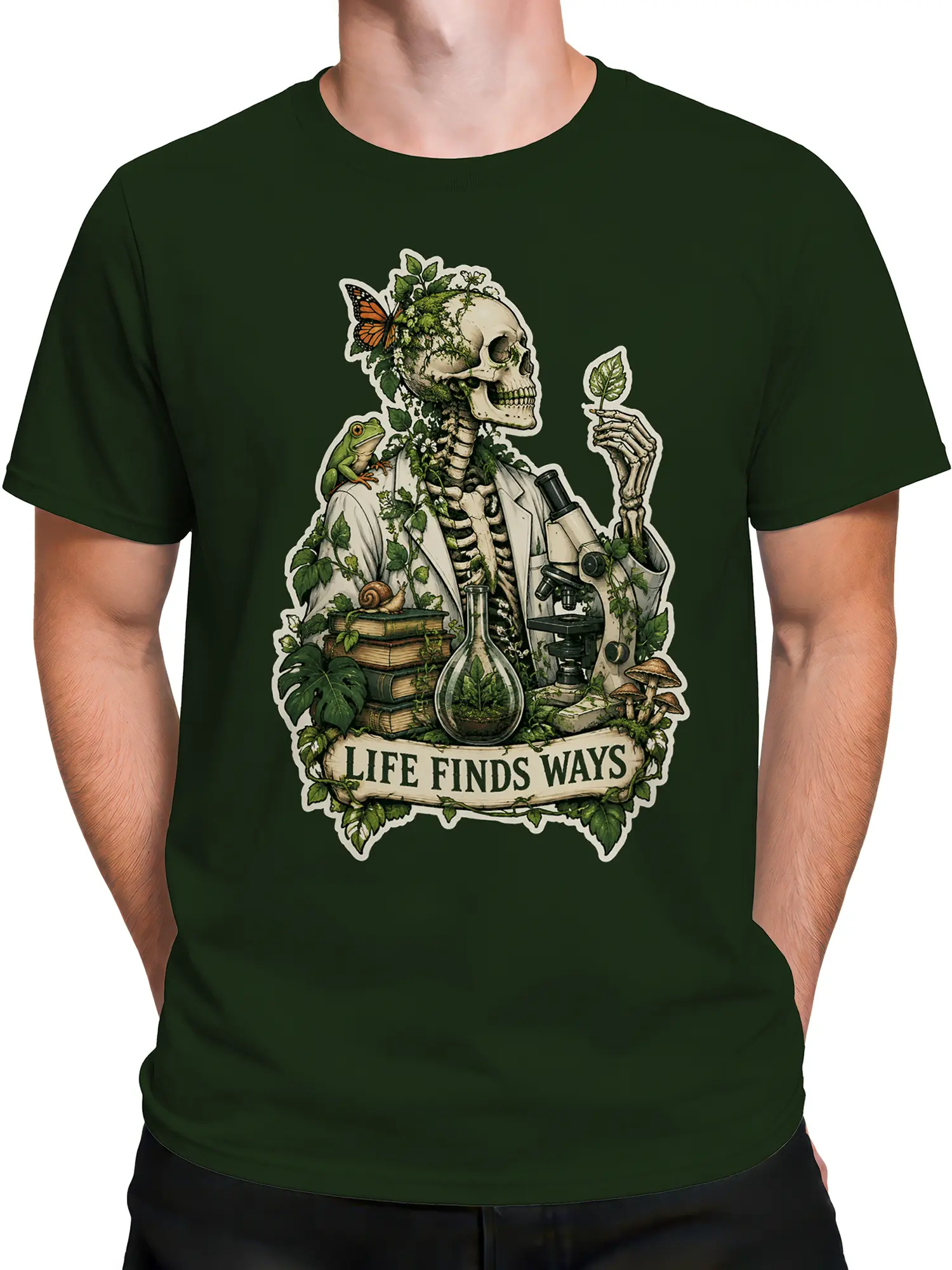 Male torso wearing a green skeleton science T-shirt with plants, frog, microscope, and message