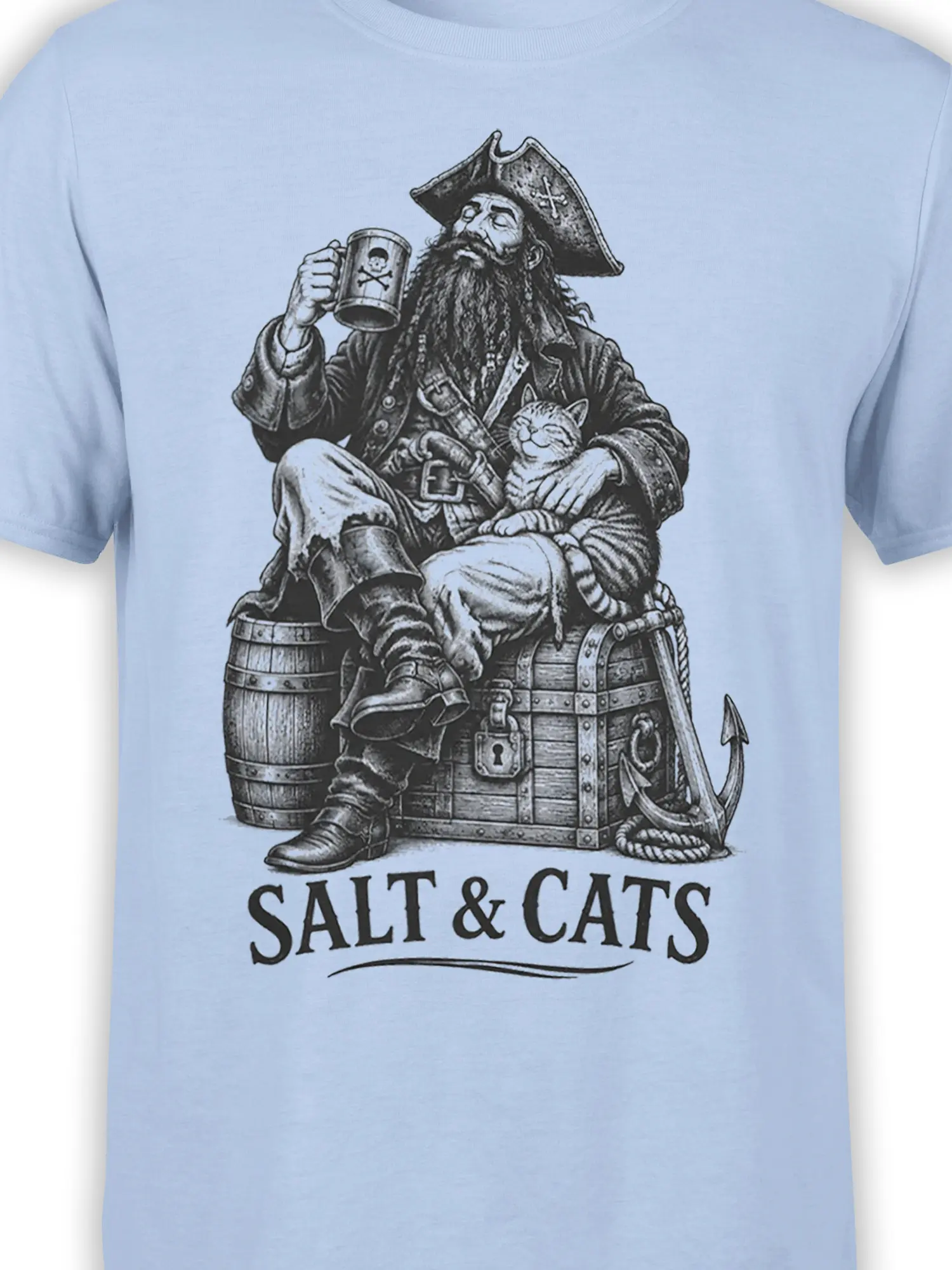 Close-up of pirate captain and striped cat artwork with treasure chest details on a light blue T-shirt