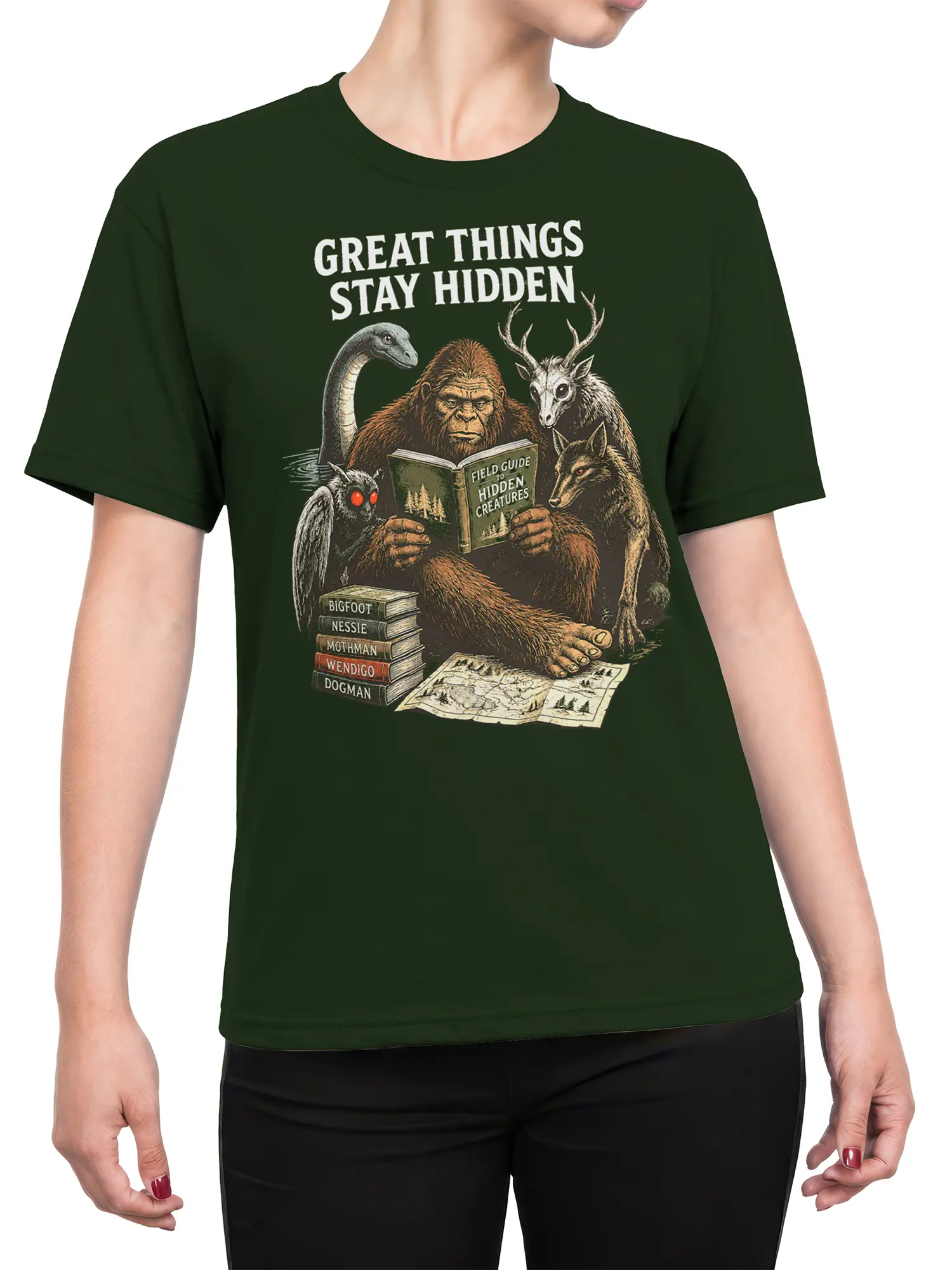 Female torso wearing a green cryptid T-shirt with vintage hidden-creature field-guide artwork
