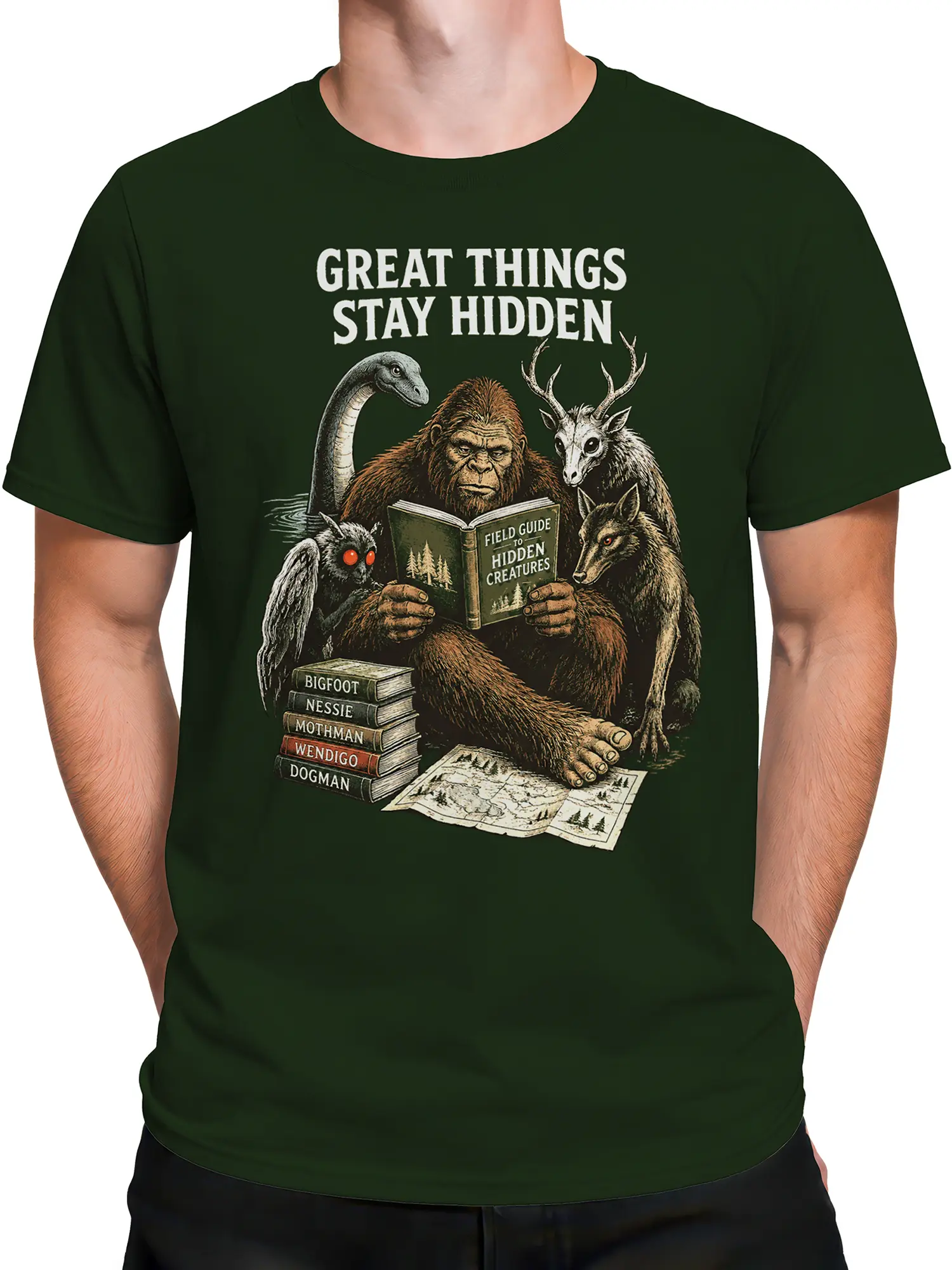 Male torso wearing a green cryptid T-shirt with vintage hidden-creature field-guide artwork