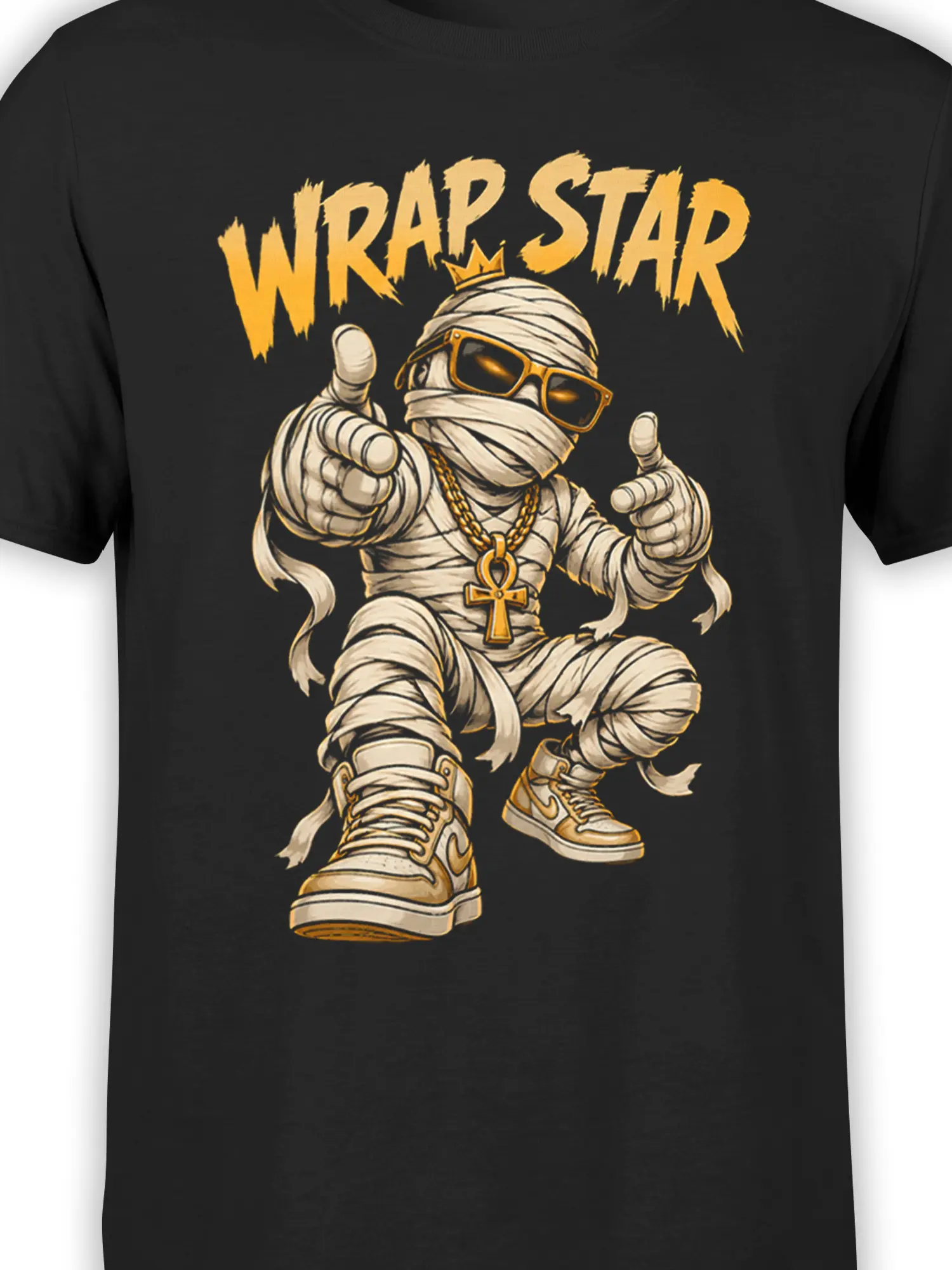 Close-up of mummy graphic with sunglasses, crown, gold chains, ankh pendant, and distressed lettering on black fabric