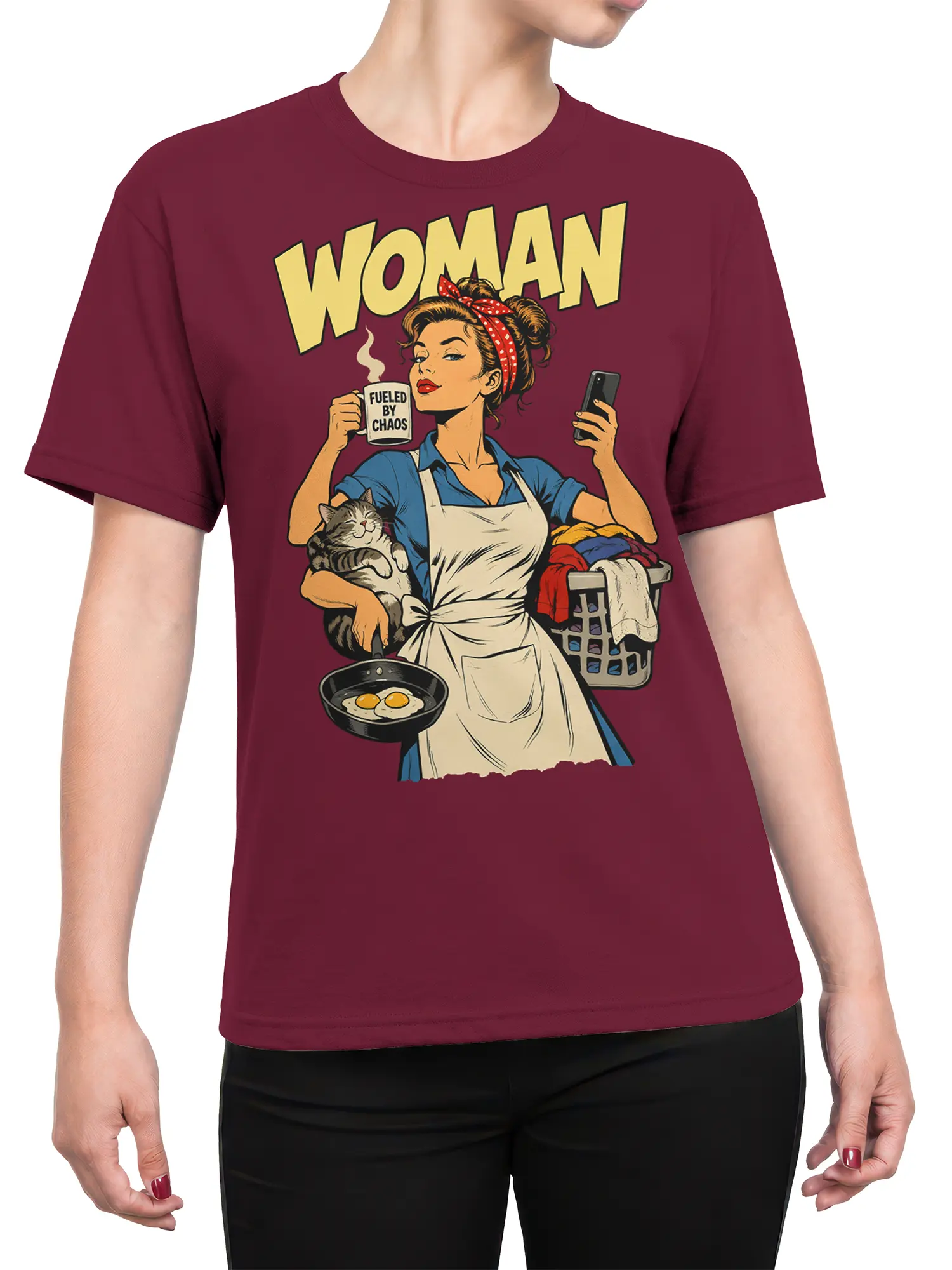 Female torso wearing a burgundy woman graphic tee with a retro multitasking woman, cat, coffee, eggs, and laundry