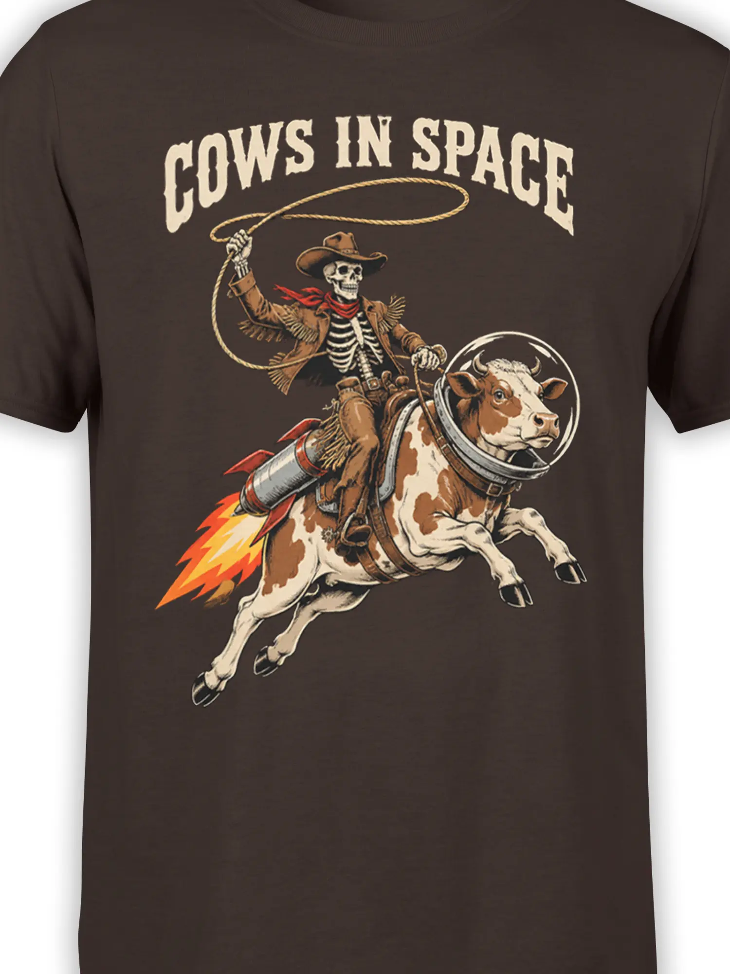 Close-up of rocket cow and skeleton cowboy graphic on a brown space-themed T-shirt