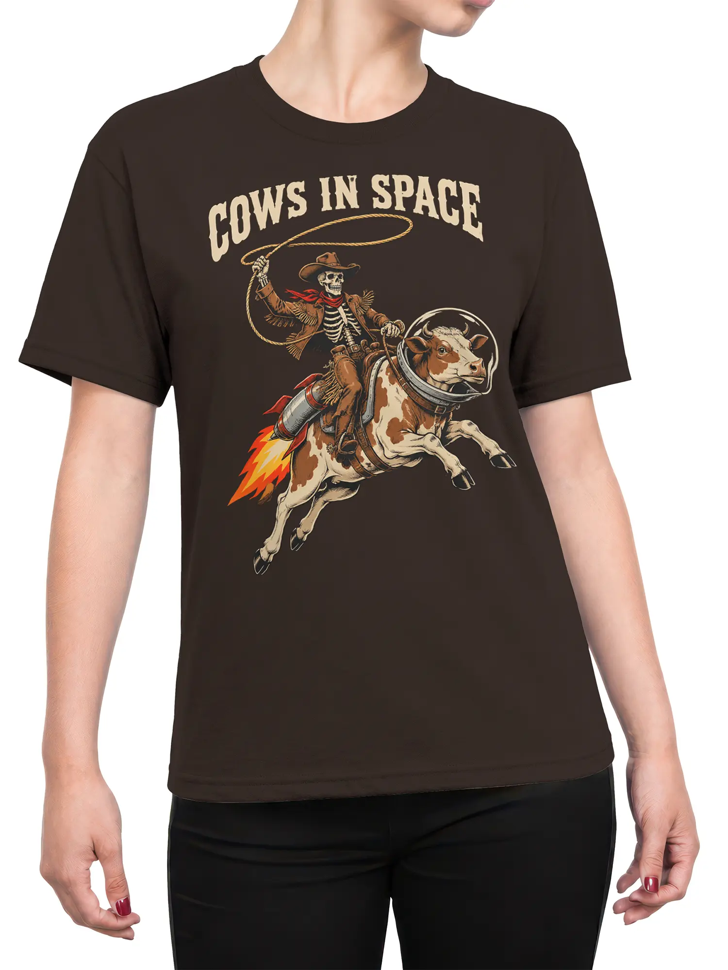 Female torso wearing a brown COWS IN SPACE T-shirt with a rocket cow and skeleton cowboy graphic