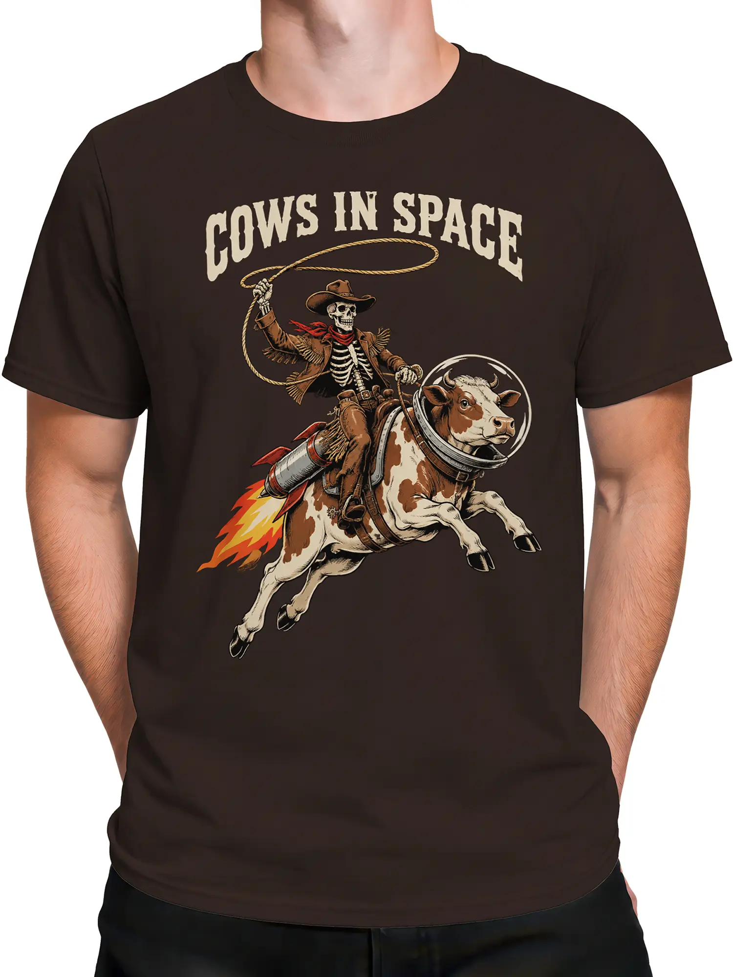 Male torso wearing a brown space graphic T-shirt with a rocket cow and skeleton cowboy design