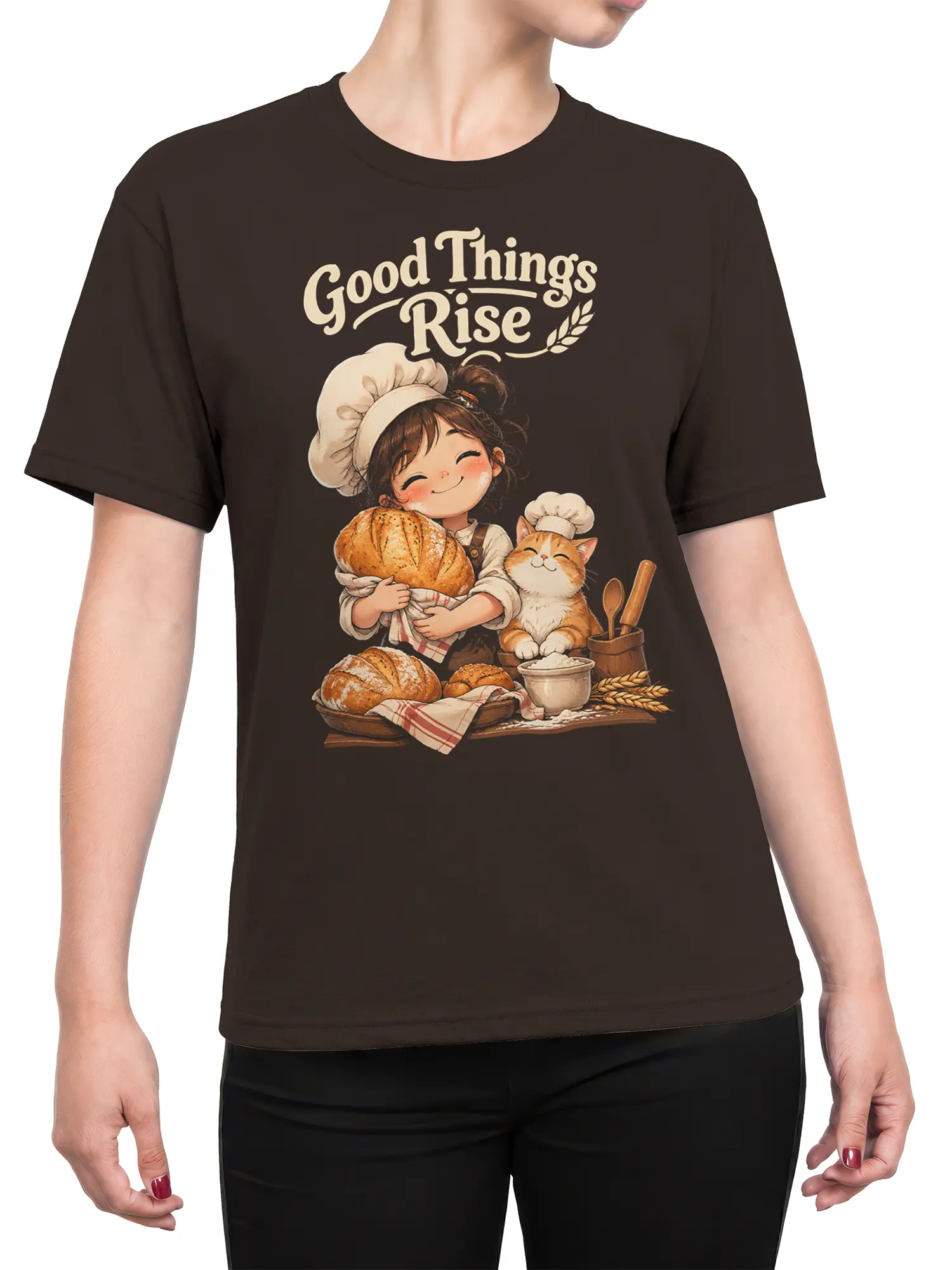 Female torso wearing brown baker cat T-shirt with bread, kitchen details, and Good Things Rise artwork