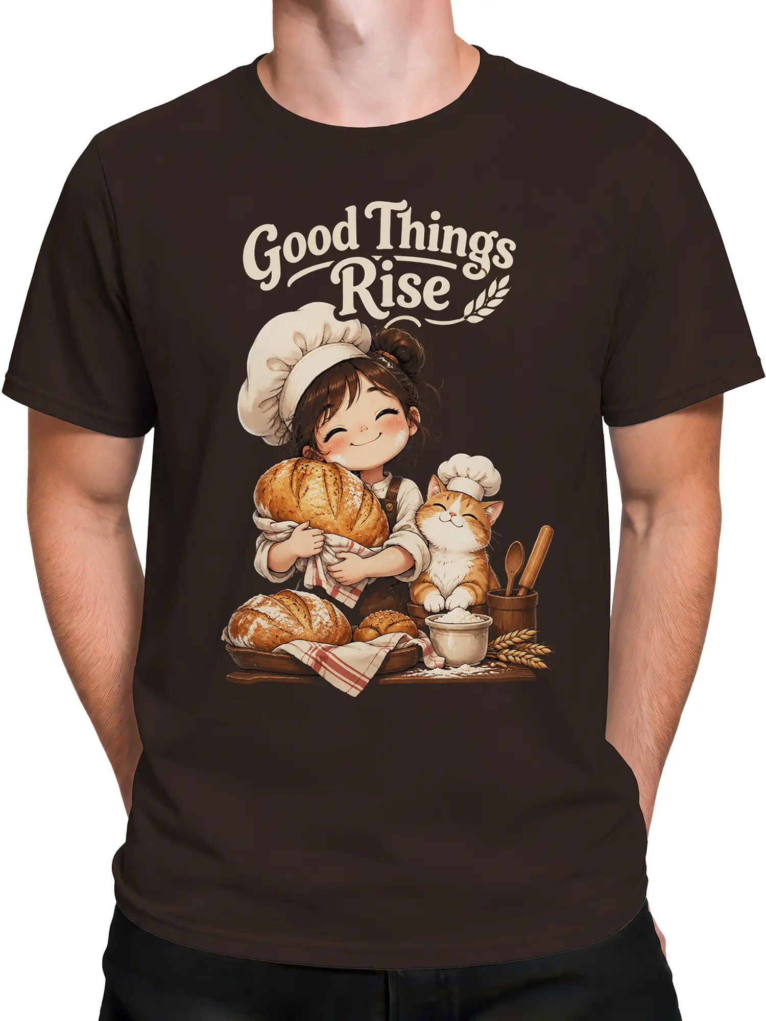 Male torso wearing brown baker cat T-shirt with smiling chef, cat, bread, and bakery artwork