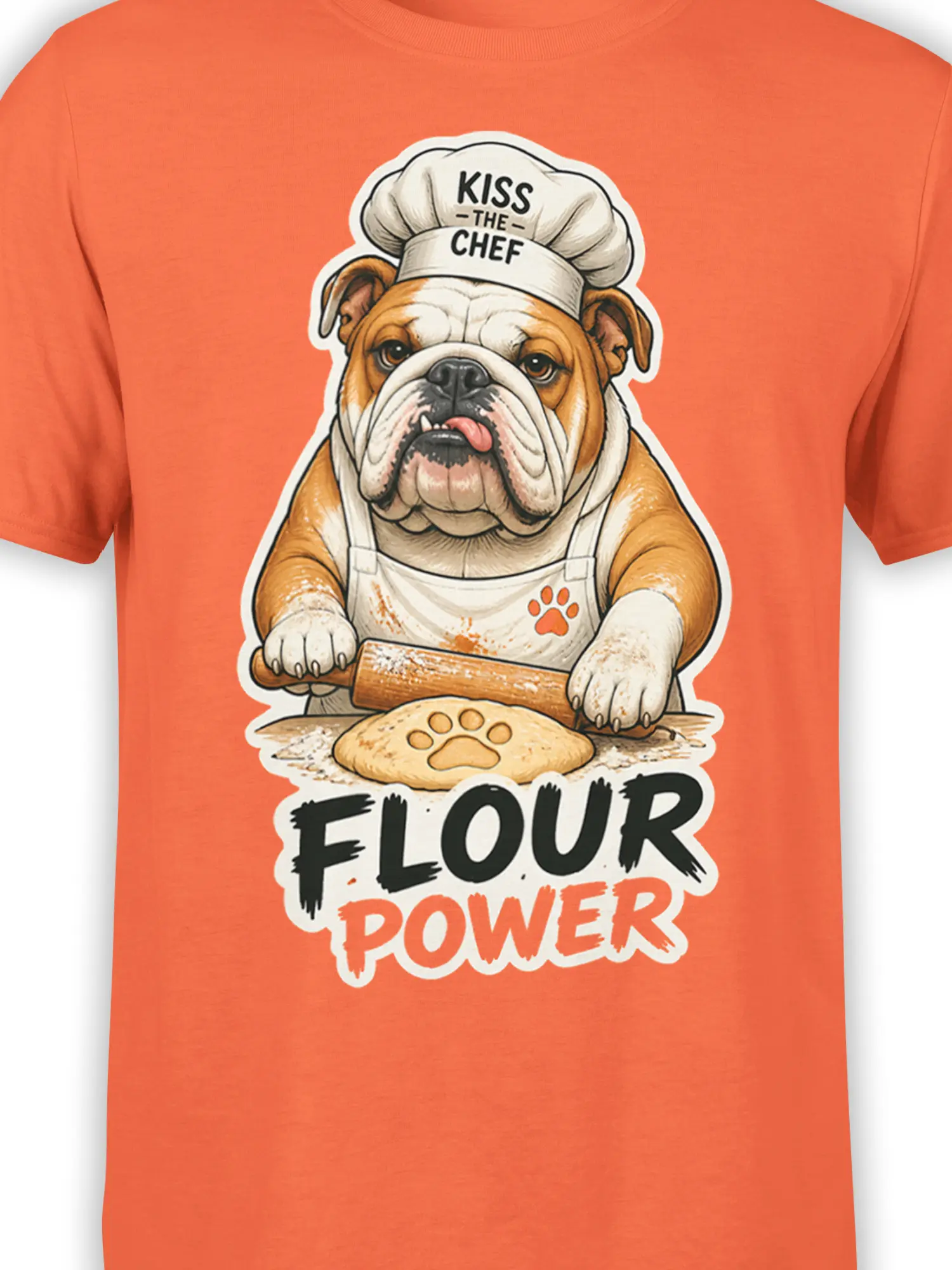 Close-up of the bulldog chef, rolling pin, paw-shaped dough, and Flour Power lettering on an orange T-shirt