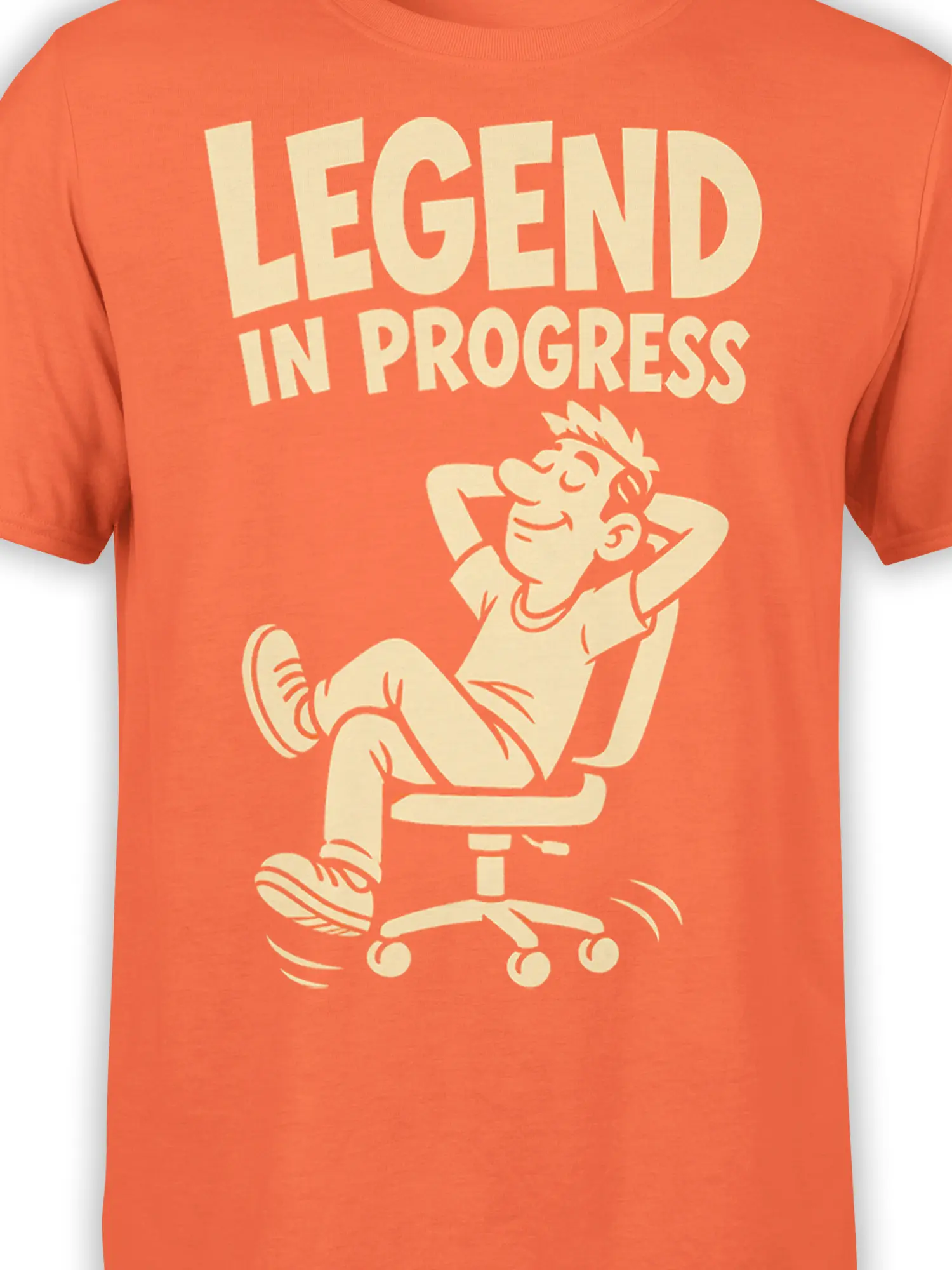 Close-up of the orange graphic tee design with cream lettering and a cartoon office worker resting in a chair