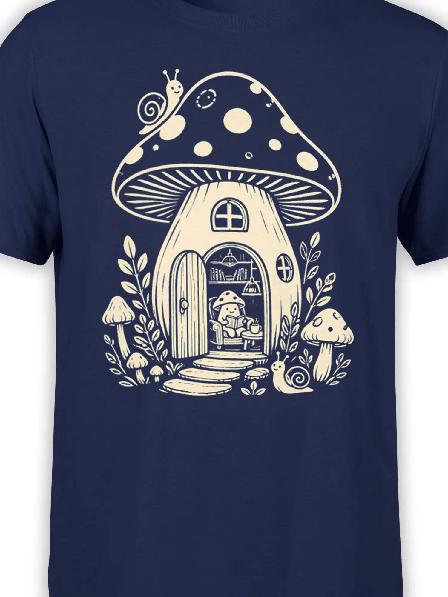 Close-up of mushroom cottage artwork with tiny reader and snails on a navy graphic tee
