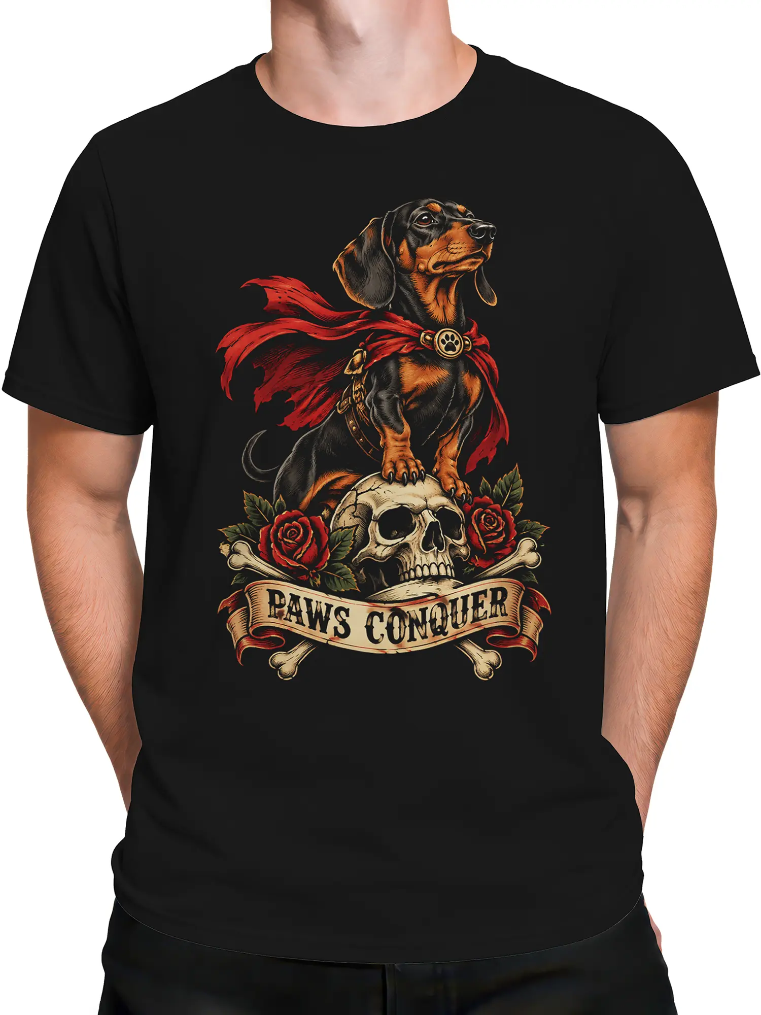 Male torso wearing a black T-shirt with a heroic caped dog, skull, roses, bones, and PAWS CONQUER design