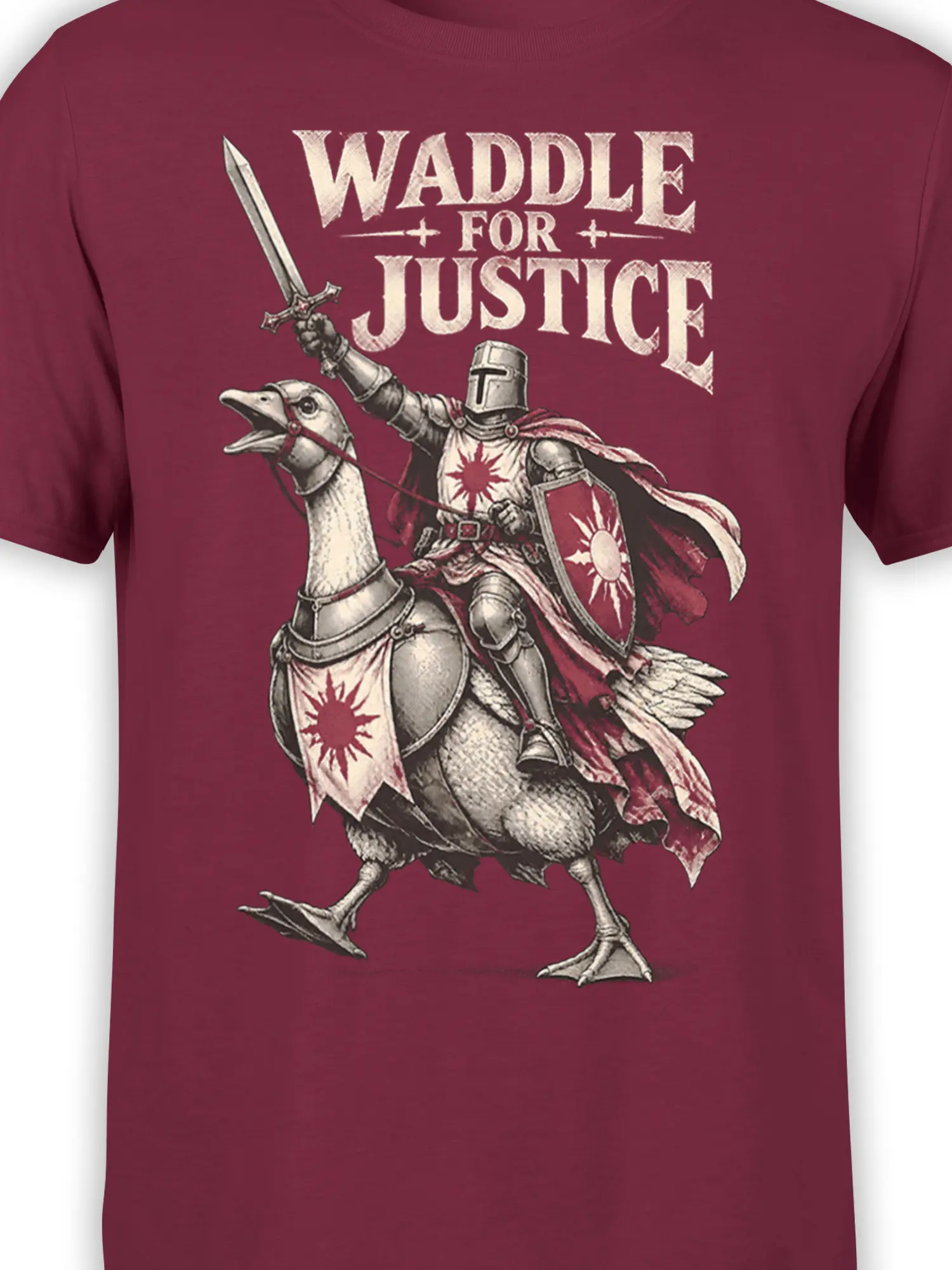Close-up of the goose knight illustration, sword, shield, and vintage lettering on a burgundy T-shirt