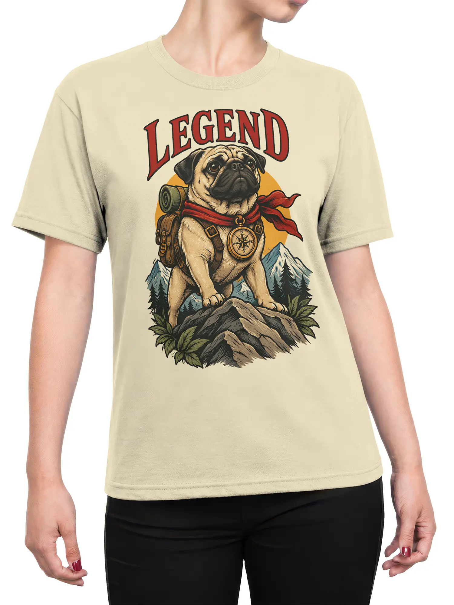 Female torso wearing a beige pug adventure T-shirt with a compass, backpack, mountains, and LEGEND graphic