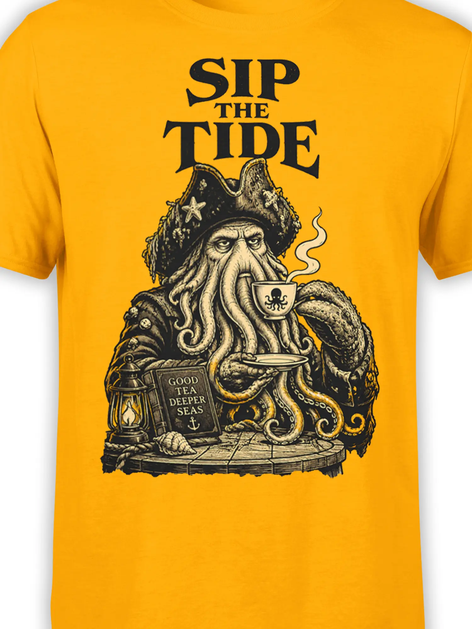 Close-up of the tea-drinking octopus design and “SIP THE TIDE” text on a yellow shirt