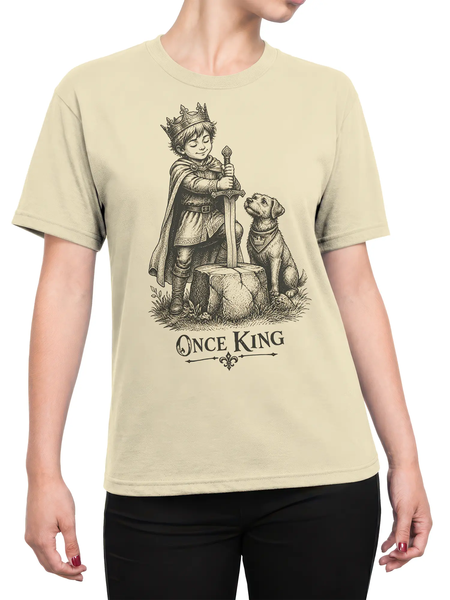 Female torso wearing a beige dog graphic tee with a crowned young king and loyal dog illustration