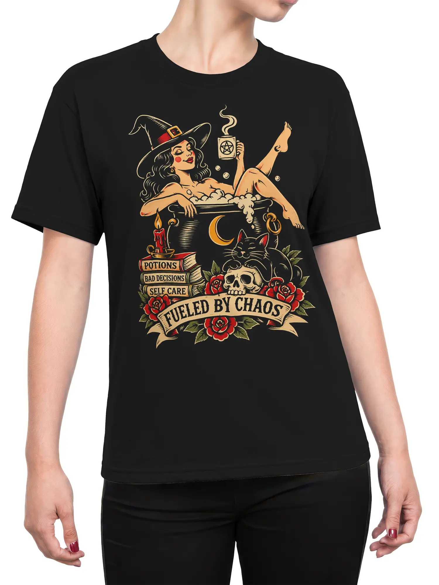 Female torso wearing a black witch T-shirt with cat, cauldron, skull, roses, and chaos artwork