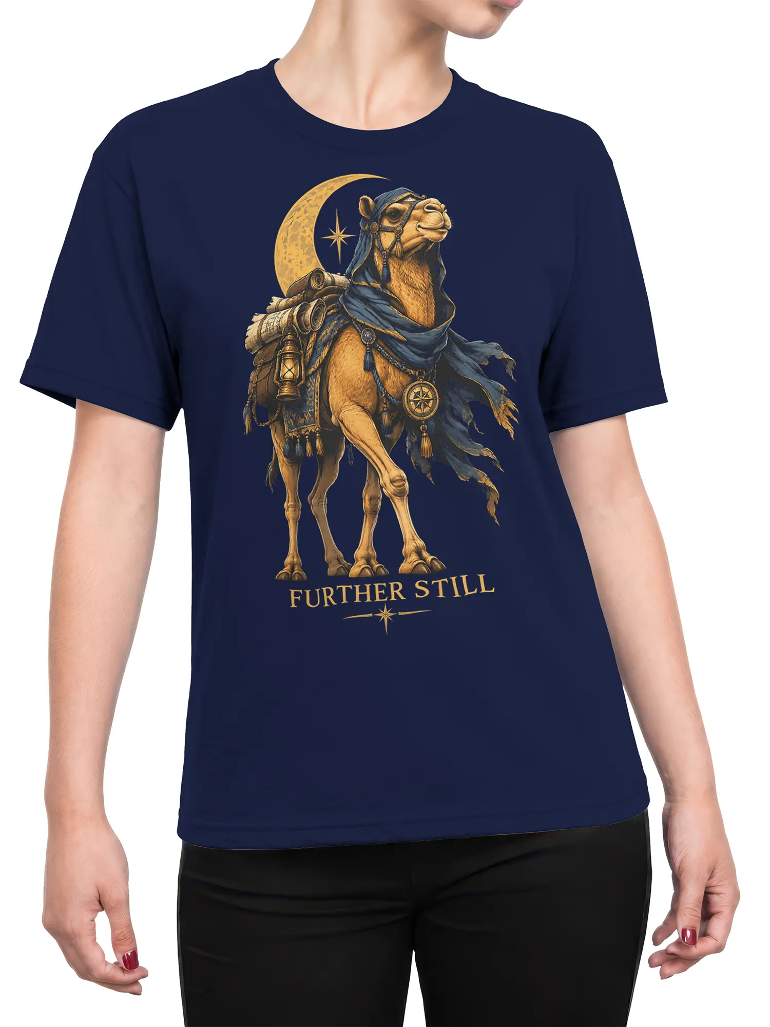 Female torso wearing a navy camel fantasy T-shirt with robed traveler artwork, crescent moon, compass, lantern, and “FURTHER STILL”