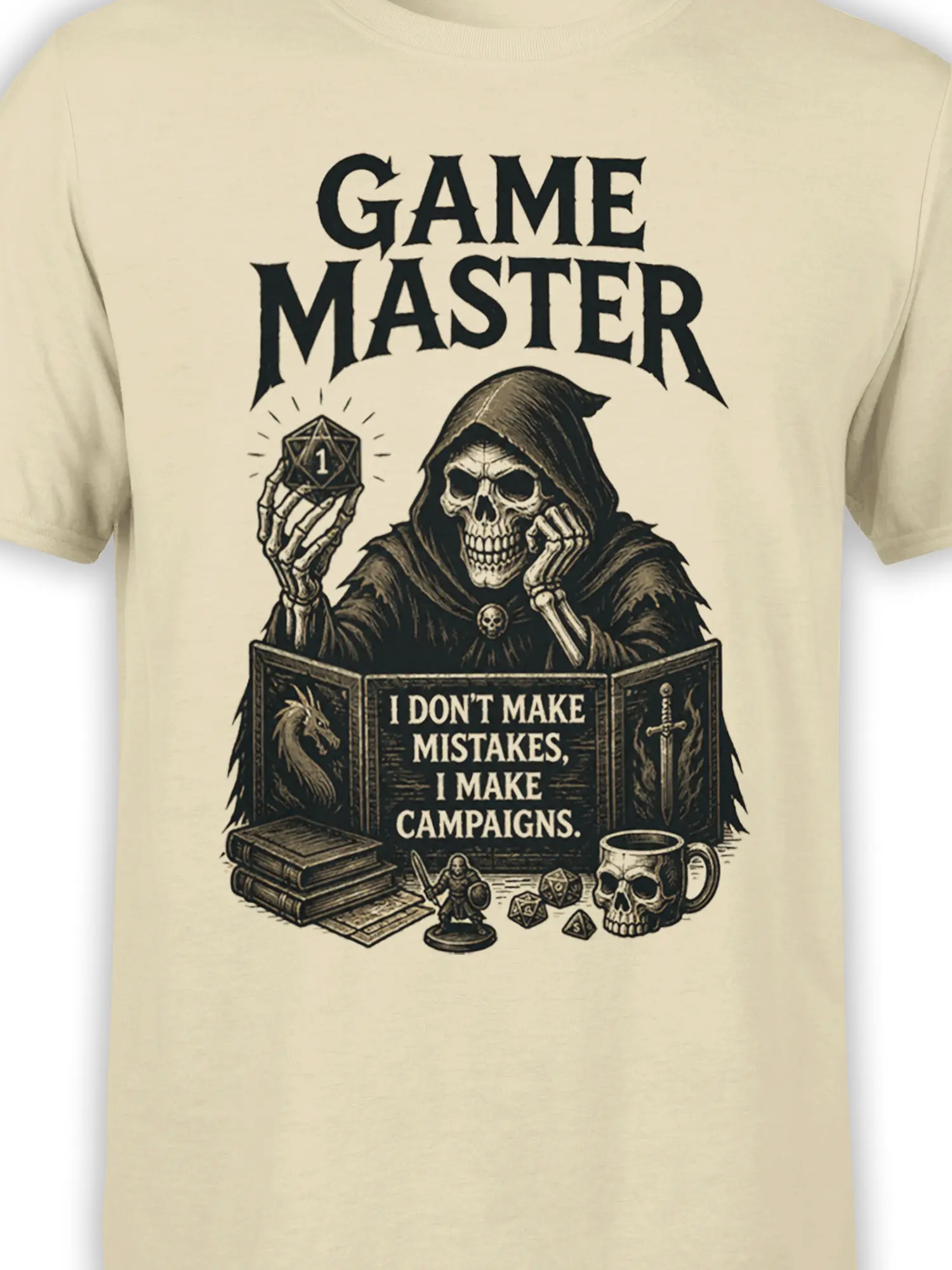 Close-up of hooded skeleton game master artwork with d20 die and campaign text on a beige T-shirt