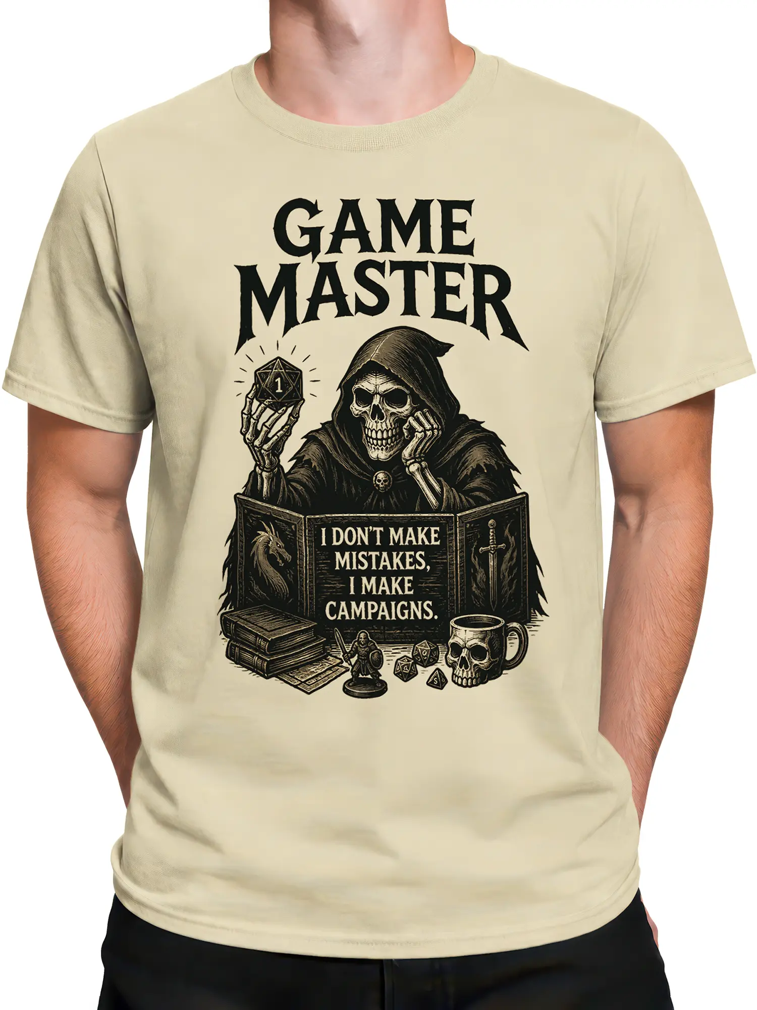 Male torso wearing a beige game master T-shirt with skeleton, dice, and vintage fantasy artwork
