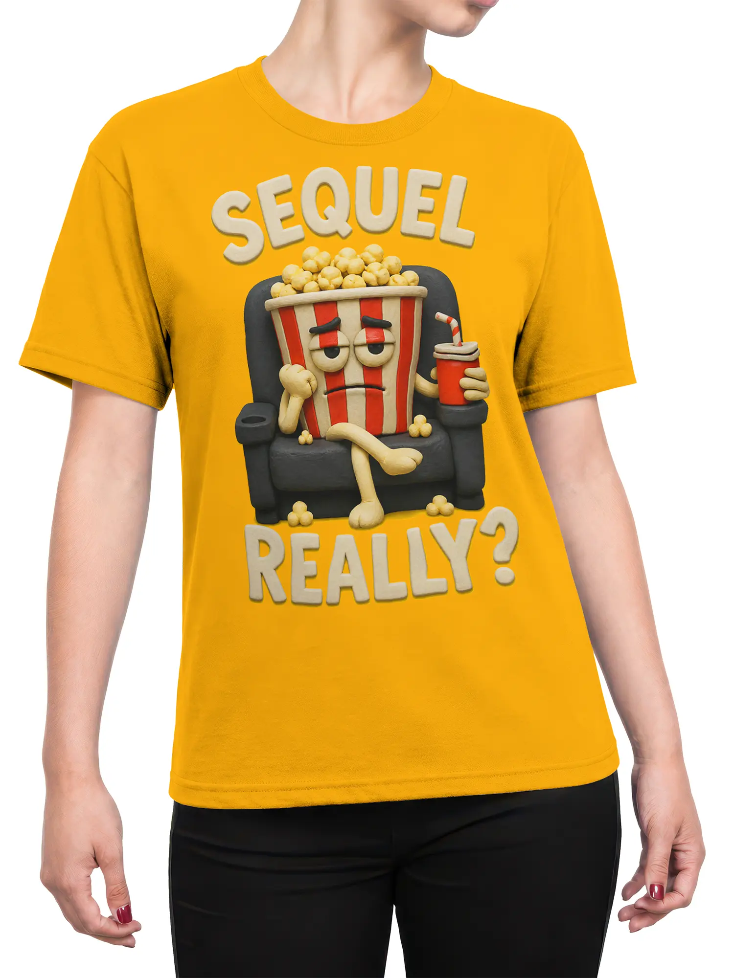 Female torso wearing a yellow popcorn graphic tee with a weary theater snack bucket and “SEQUEL REALLY?” text
