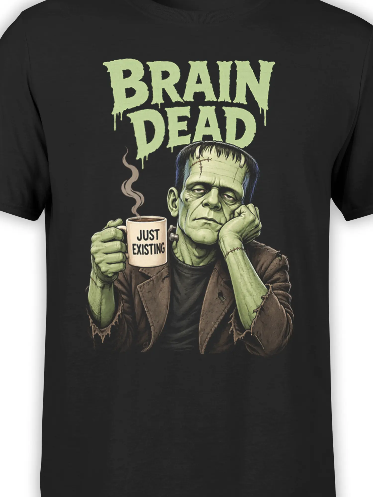 Close-up of green stitched creature and steaming mug on black Brain Dead graphic shirt