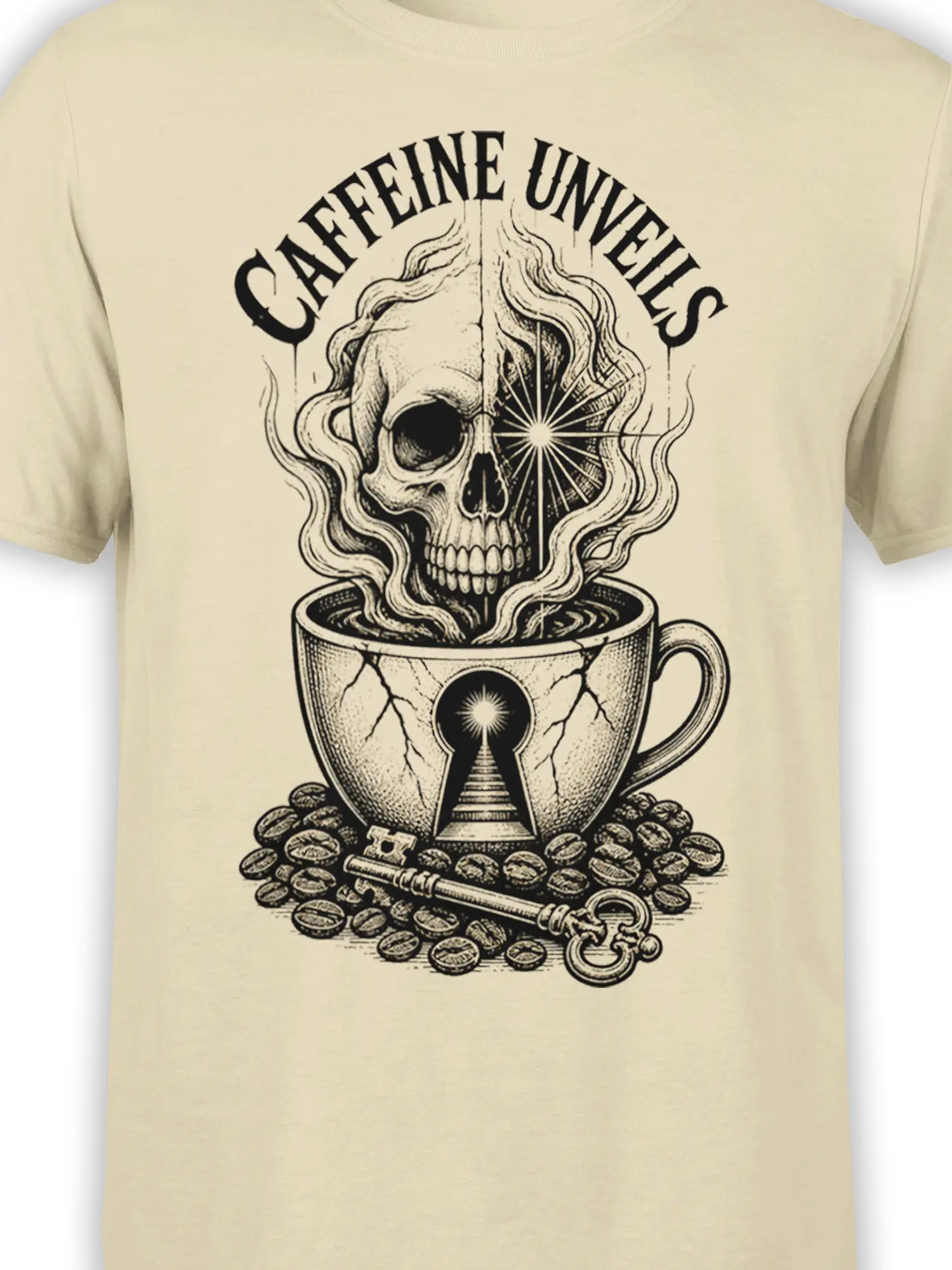 Close-up of the beige coffee shirt design showing the skull, cracked cup, keyhole, coffee beans, and black vintage linework