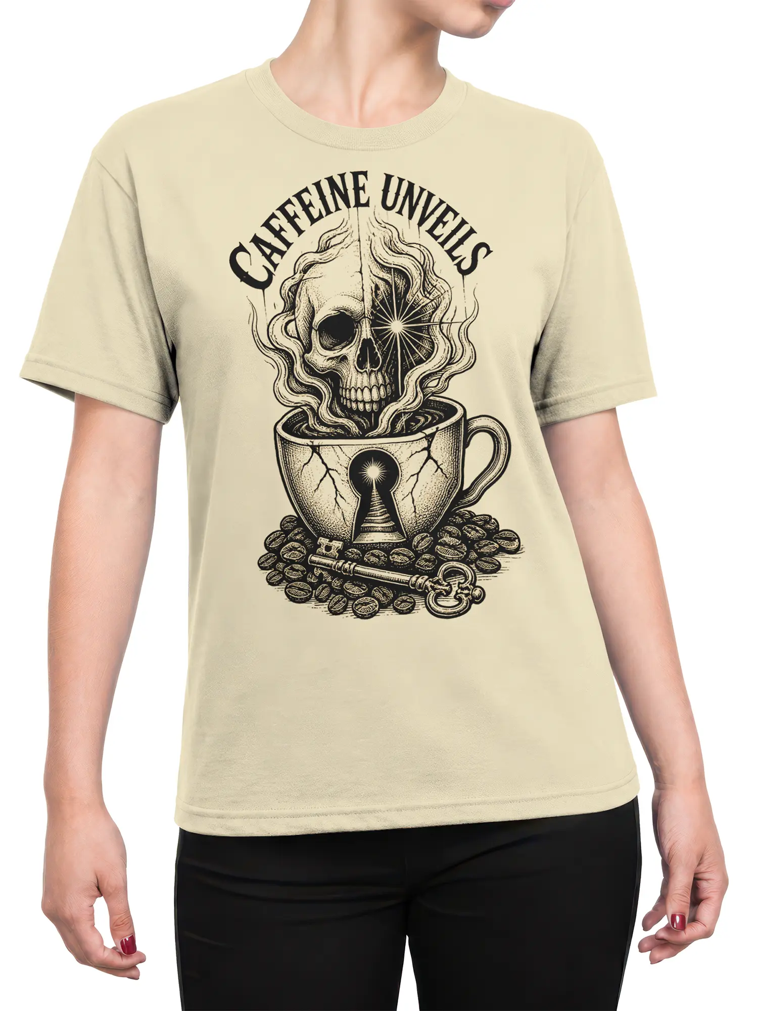 Female torso wearing a beige coffee graphic tee with a skull cup design and “CAFFEINE UNVEILS” text in black ink