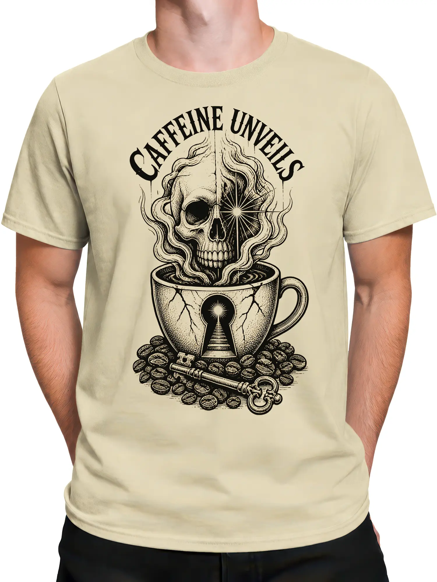 Male torso wearing a beige skull coffee graphic tee with vintage black artwork, coffee beans, and a cracked cup
