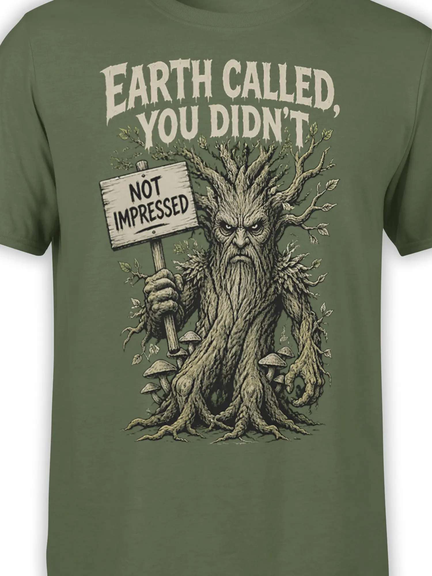 Close-up of the grumpy tree creature and “NOT IMPRESSED” sign on a green shirt